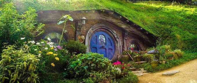 Image of Hobbiton featuring a Hobbit house with a round door