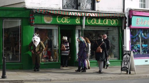 The green exterior of the Cat & Cauldron storefront in Glastonbury