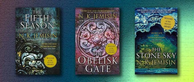 The collage of books shows the entirety of the Broken Earth series by N.K. Jemisin